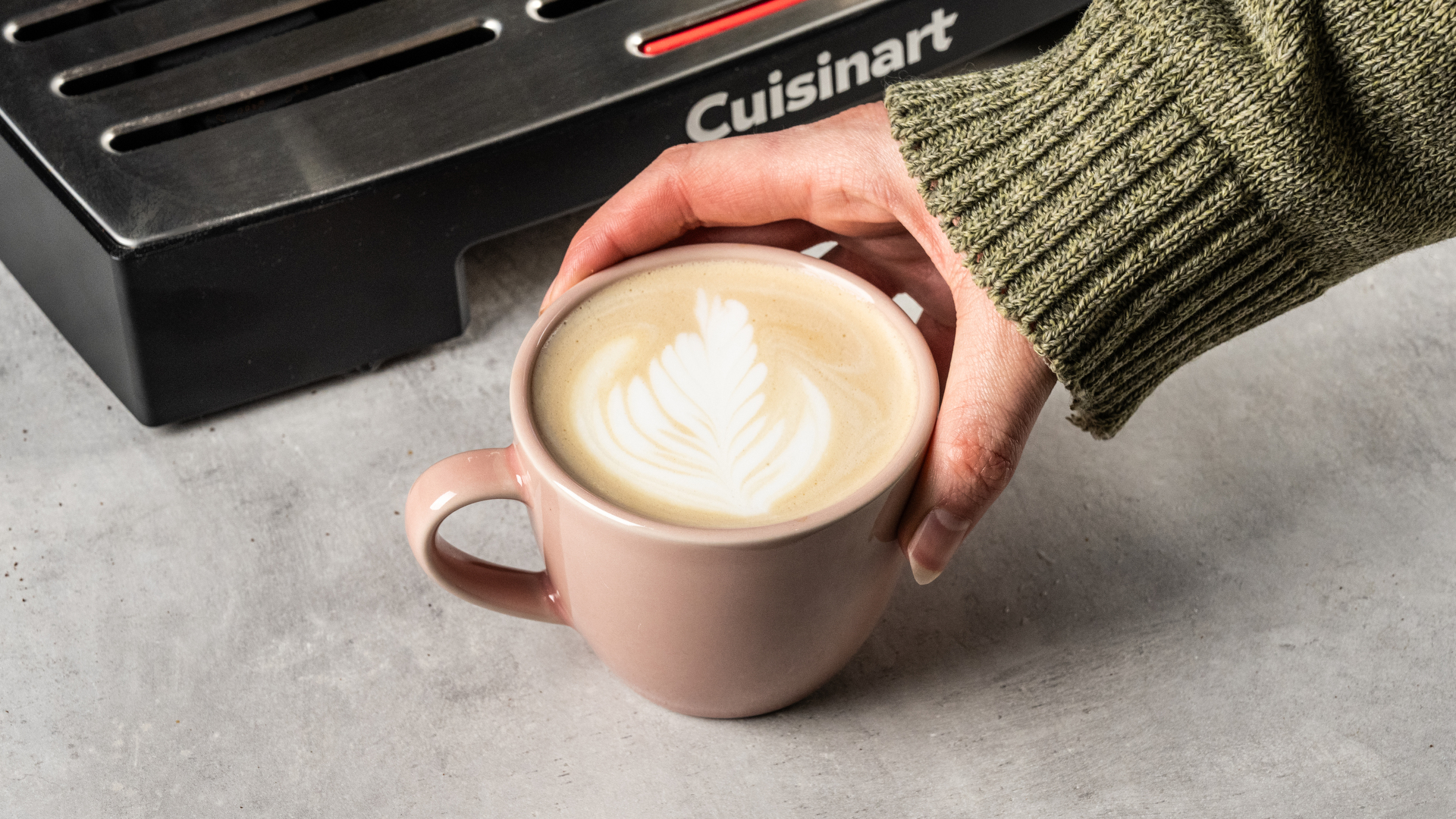 the cuisinart grind, tamp and brew espresso machine with built-in grinder photographed against a blue tom's guide background