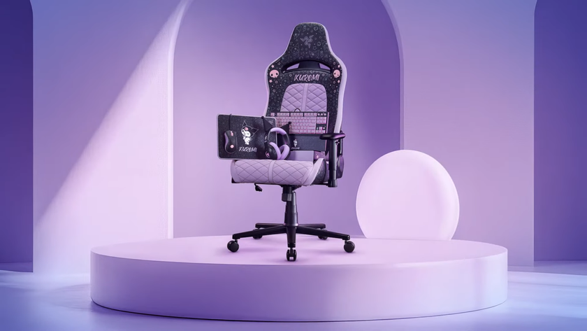 The Kuromi Razer collection, including the pointy-eared headset, mouse mat, mouse, and tenkeyless keyboard, is all perched on the seat of a purple and black gaming chair. The chair itself is also Kuromi themed, and it sits on top of a lilac plinth inside of a similarly coloured room. 