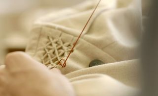 A smocked detail on the neck of a women’s coat is inspired by Leonardo da Vinci’s knot and geometric sketches