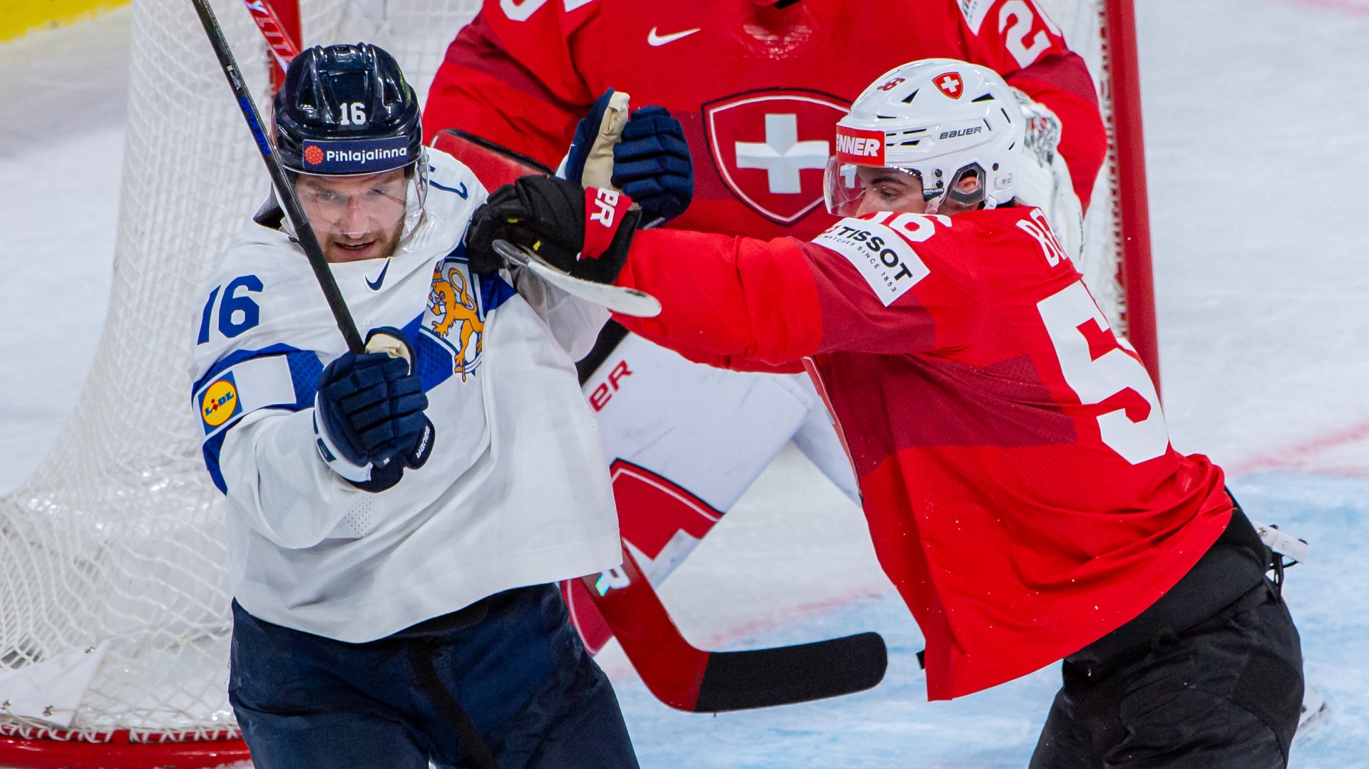Finland's Aleksander Barkov clashes with Switzerland's Tim Berni at the 2026 IIHF World Championship