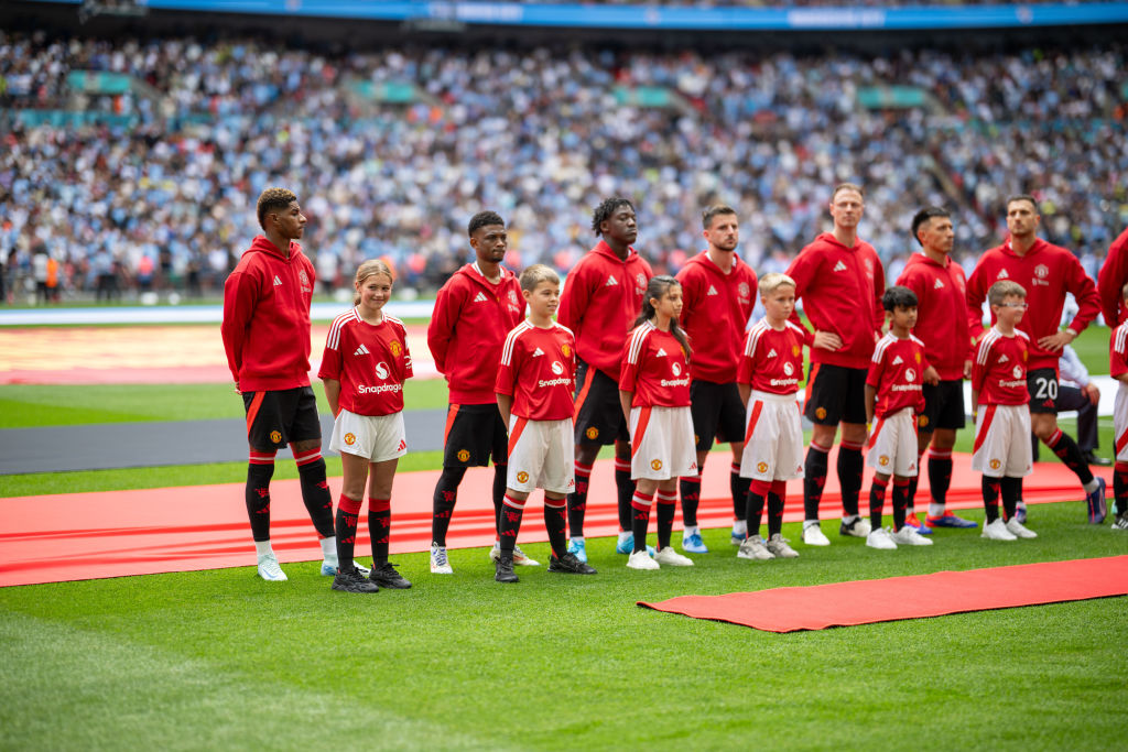 Manchester United squad for 2024/25 LONDON, ENGLAND - AUGUST 10: Marcus Rashford, Amad, Kobbie Mainoo, Mason Mount, Jonny Evans, Lisandro Martinez and Diogo Dalot of Manchester United line up ahead of the 2024 FA Community Shield match between Manchester United and Manchester City at Wembley Stadium on August 10, 2024 in London, England. (Photo by Ash Donelon/Manchester United via Getty Images)