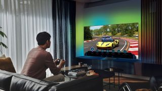 Man playing a Racing game on a Samsung OLED TV