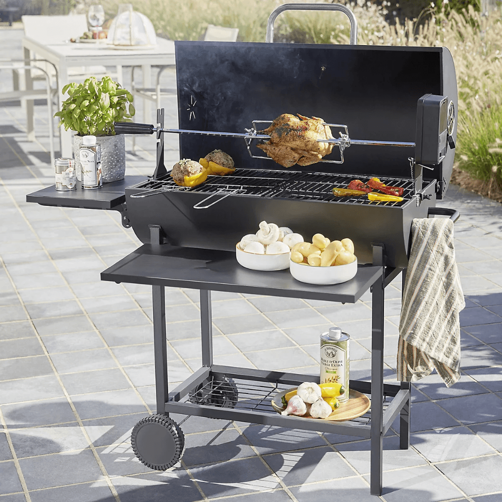 A charcoal BBQ with a chicken cooking on the grill