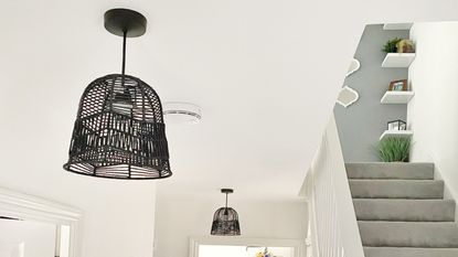 hallway with grey stairs and black pendant light