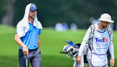 Thomas Detry walks with his caddie