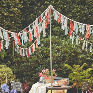 Blue and pink bunting zoning patio area in garden