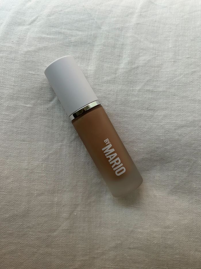 The Makeup By Mario Surrealskin Natural Finish Foundation on a white linen background