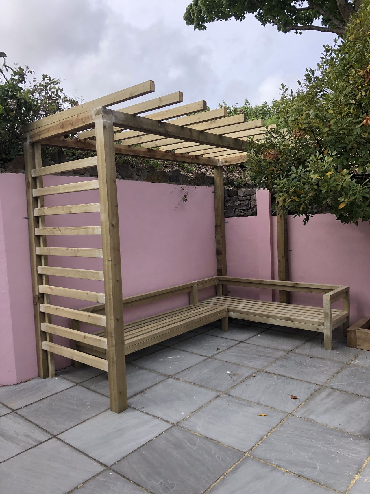 DIY outdoor sofa underneath a DIY timber pergola