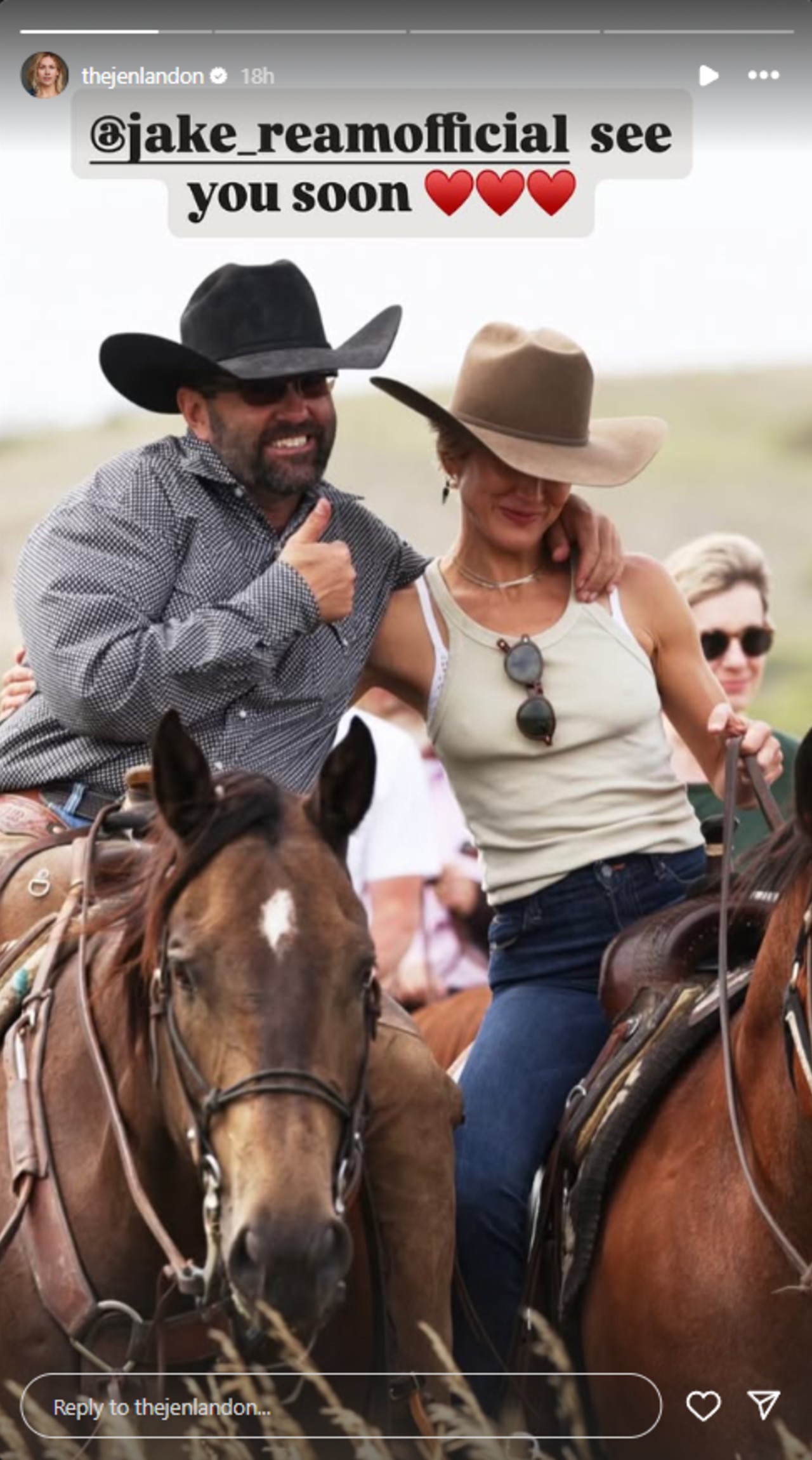 Jake Ream and Jen Landon on horses. Jake has his right arm around her shoulder and is giving a thumbs up with his left hand.