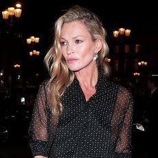 Kate Moss wearing a sheer polka dot blouse during Paris Fashion Week
