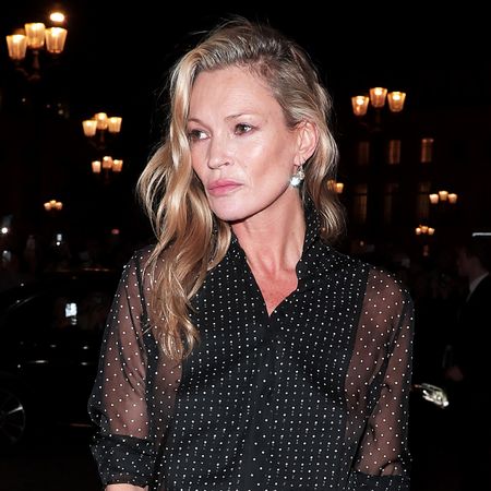 Kate Moss wearing a sheer polka dot blouse during Paris Fashion Week