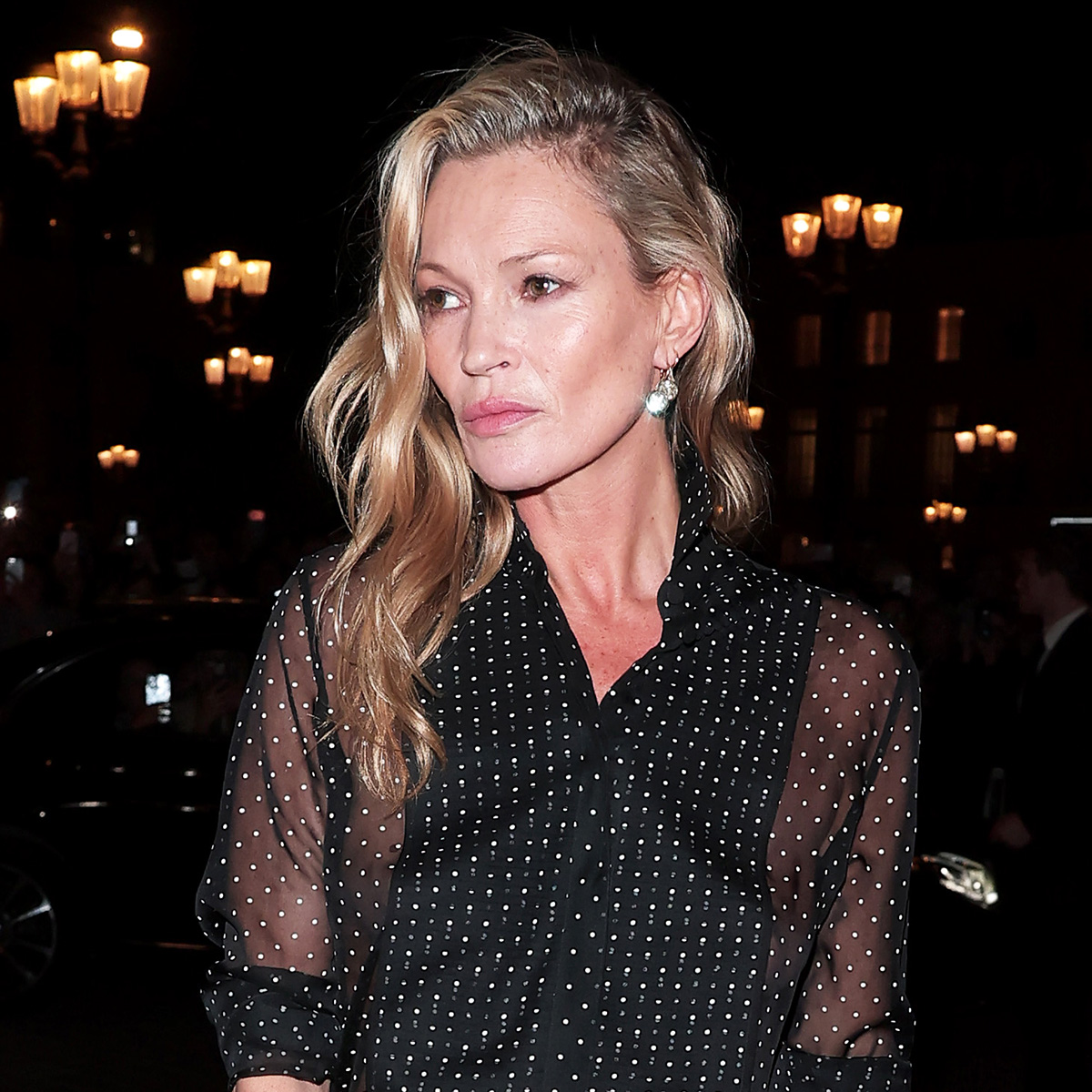 Kate Moss wearing a sheer polka dot blouse during Paris Fashion Week