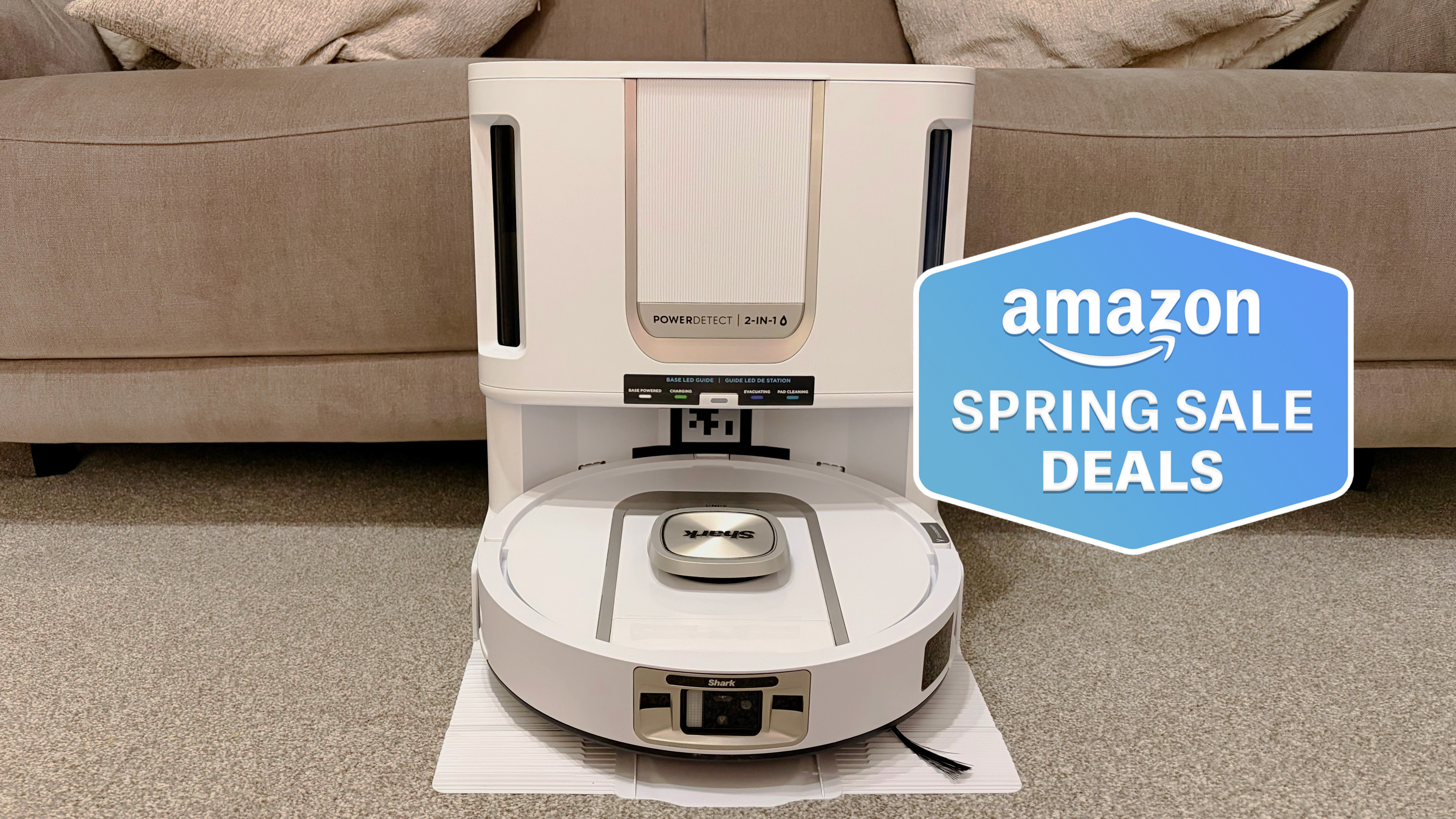 Shark PowerDetect 2-in-1 ThermaCharged NeverTouch photographed on docking station on carpet in front of a sofa