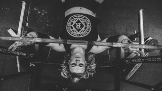 woman bench pressing on adjustable weight bench