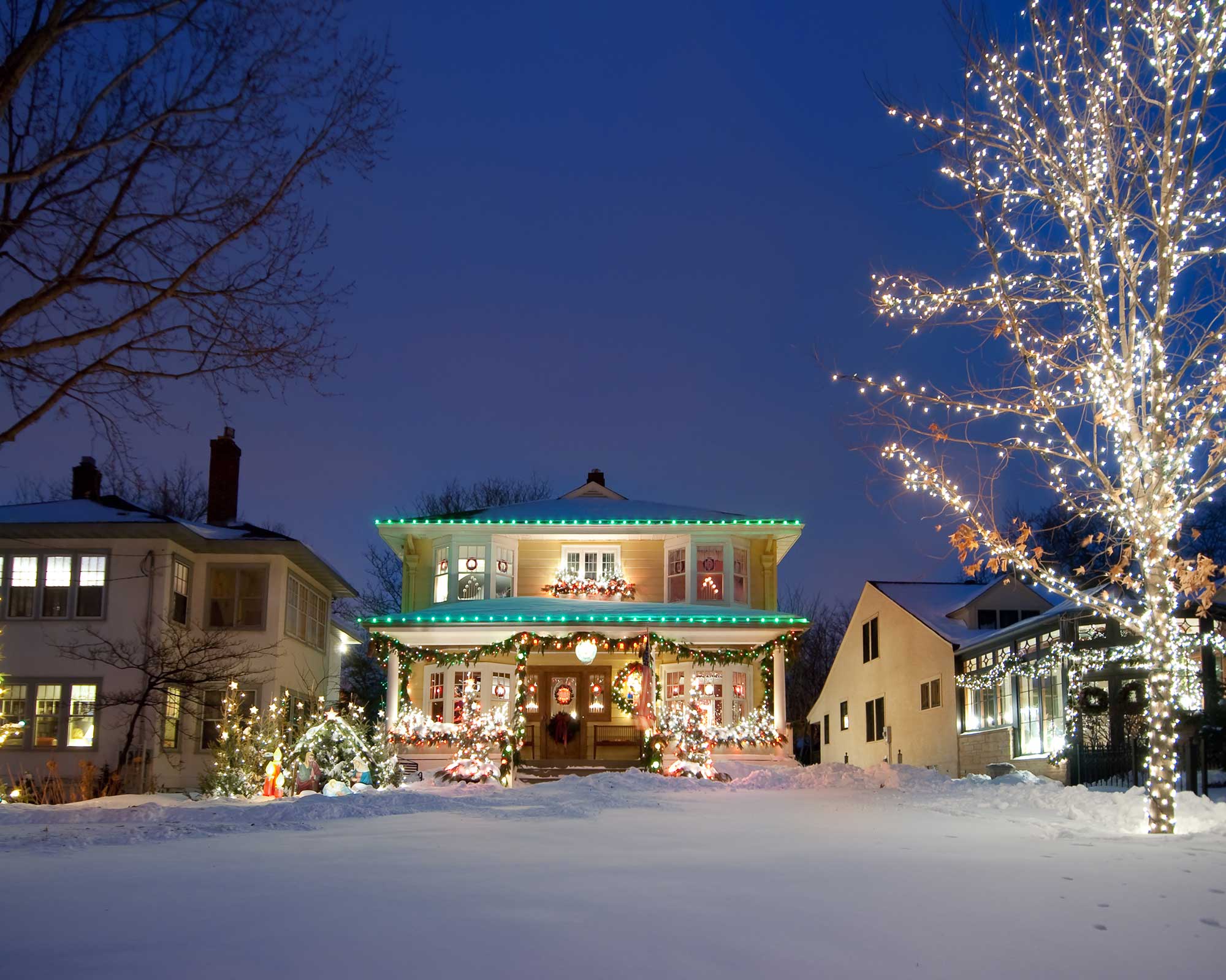 Christmas lights on house in snow