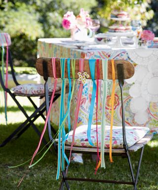 An outdoor chair decorated with colorful ribbons