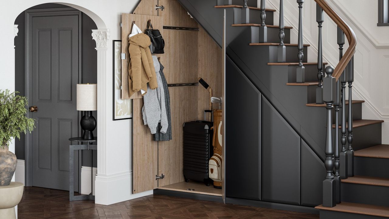 sleek hallway with Hammonds under-stair storage, dark grey staircase, and a door going into the kitchen