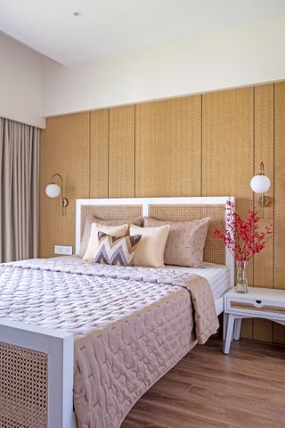 A bedroom with textural wall behind the bed