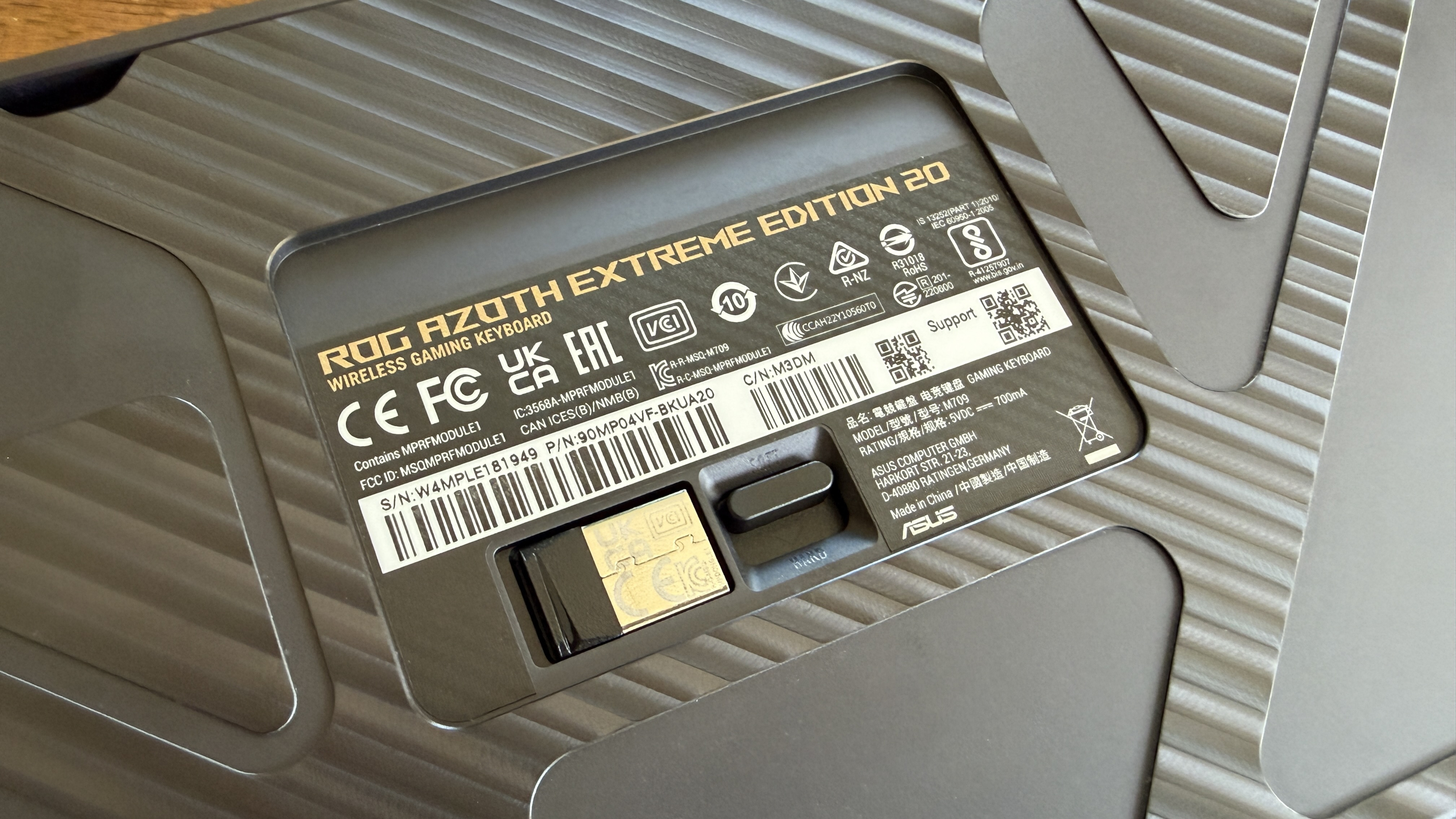 Back of a ROG Azoth Extreme Edition 20 wireless gaming keyboard with certification labels.