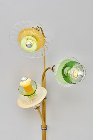 Triple stemmed lamp with glass shades in green, yellow and clear glass.