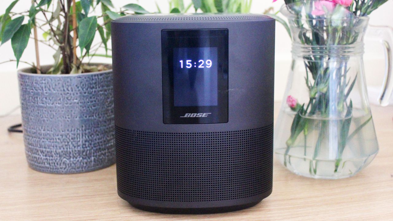 Bose Smart Speaker 500 on table with plant and vase of flowers