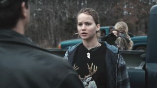 Jennifer Lawrence appears shocked when talking to someone by a truck in Winter's Bone.