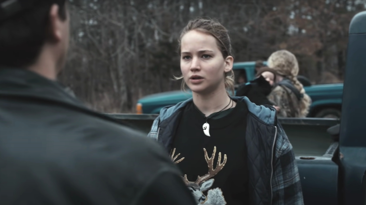 Jennifer Lawrence appears shocked when talking to someone by a truck in Winter's Bone.