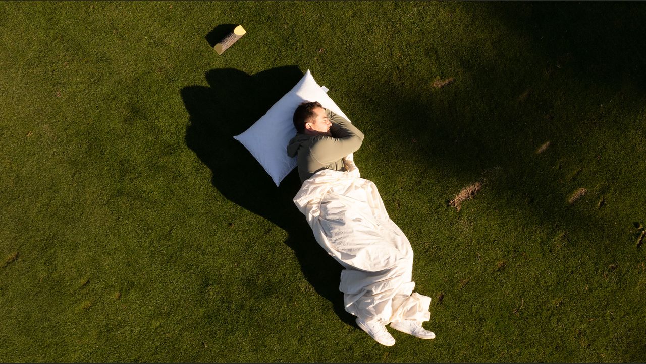 Golfer sleeping on a tee box