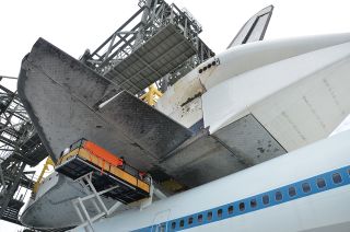 Space shuttle Endeavour is “soft mated” to the Shuttle Carrier Aircraft (SCA) inside the Mate-Demate Device at the Shuttle Landing Facility at NASA's Kennedy Space Center in Florida on Sept. 14, 2012. The operation is the last of its type for the space shuttle program era.
