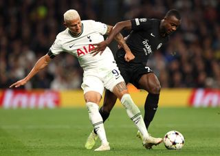 Richarlison of Tottenham Hotspur battles for possession with Evan Ndicka of Eintracht Frankfurt during the UEFA Champions League group D match between Tottenham Hotspur and Eintracht Frankfurt at Tottenham Hotspur Stadium on October 12, 2022 in London, England.