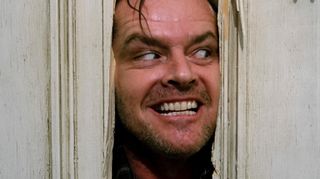 Jack Torrance played by Jack Nicholson, peeking his head through a door in The Shining