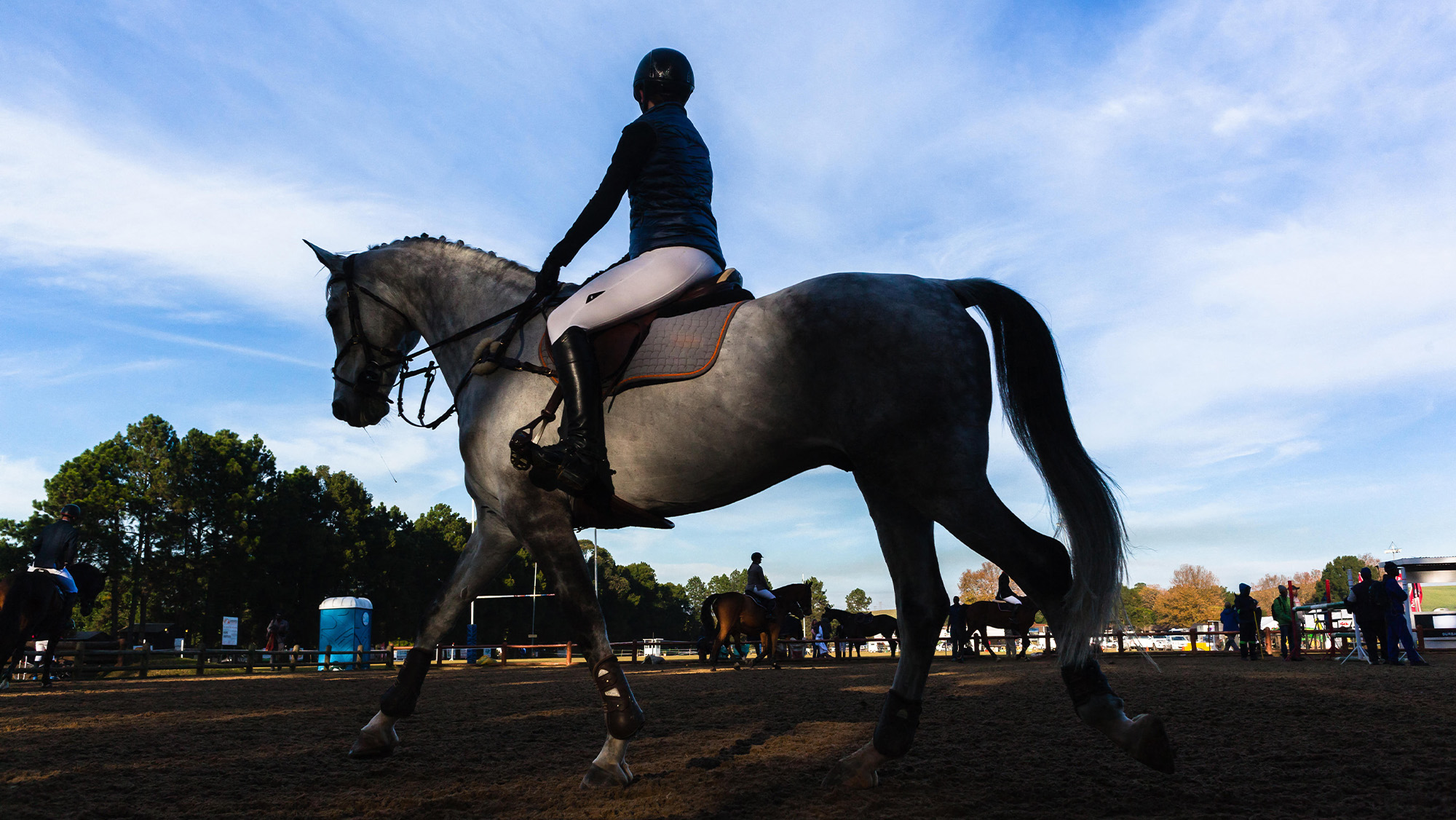 Unidentifiable rider in warm-up arena
