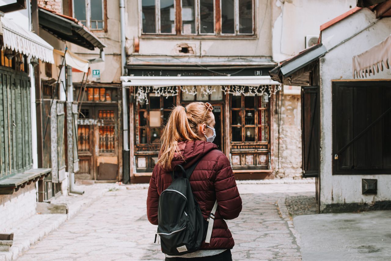 Woman standing in an empty street in Sarajevo, Bosnia and Herzegovina.