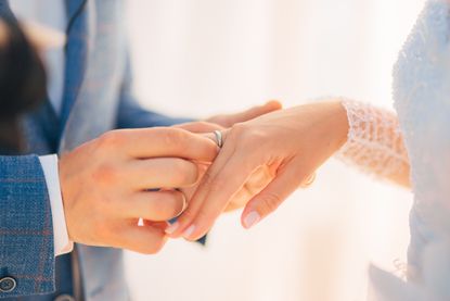 Newlyweds exchanging rings.