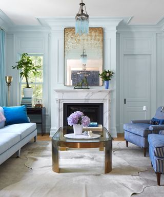 traditional living room with light blue walls and vintage decor