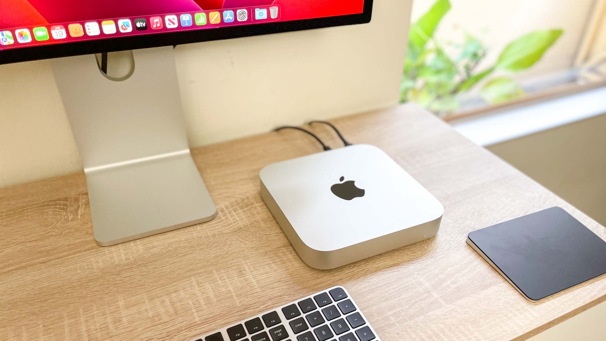 Apple Mac mini M2 on a desk, plugged in