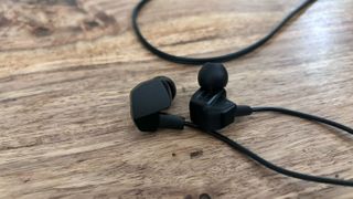 A shot of the Final VR3000 earbuds on a wooden table.