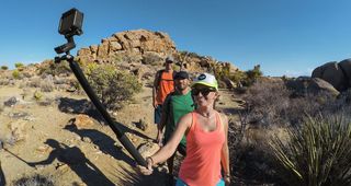 Group of people walking in the desert with a GoPro El Grande