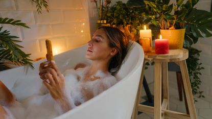 Best self care apps: A woman using one of the best self care apps on her phone