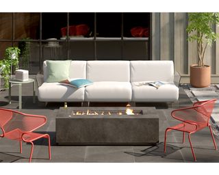 Outdoor living room with white sofa decor and coral colored metal accent chair decor
