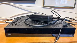 a cable box, coaxial cord and power supply on the counter top after cutting the cord