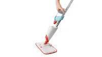 The best mop for tile floors: OXO Microfibre Spray Mop with Slide-Out Scrubber in white with hand reaching for water tank