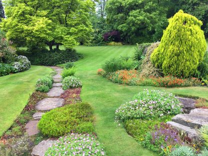 Large lawn area with rockeries and rock path