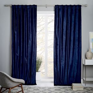 Luster Velvet Curtains against a gray wall.