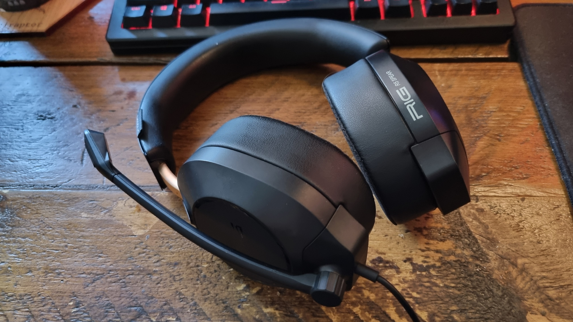 A Rig R5 Spear Max HD gaming headset on a wooden table