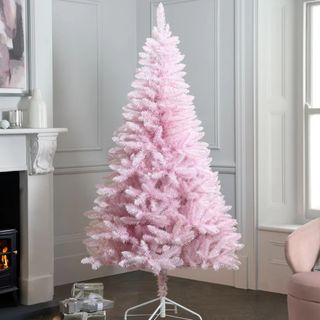 Next Pink Christmas tree in a living room next to a fireplace