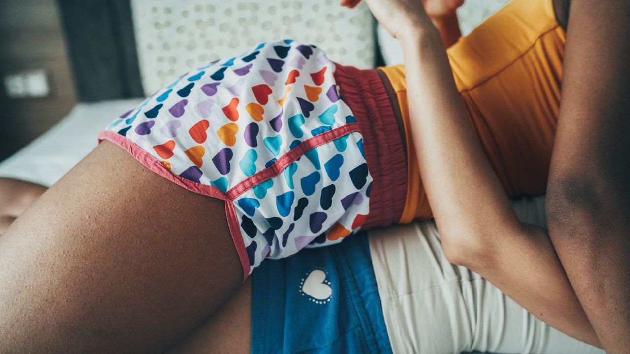 women having sex in colorful shorts