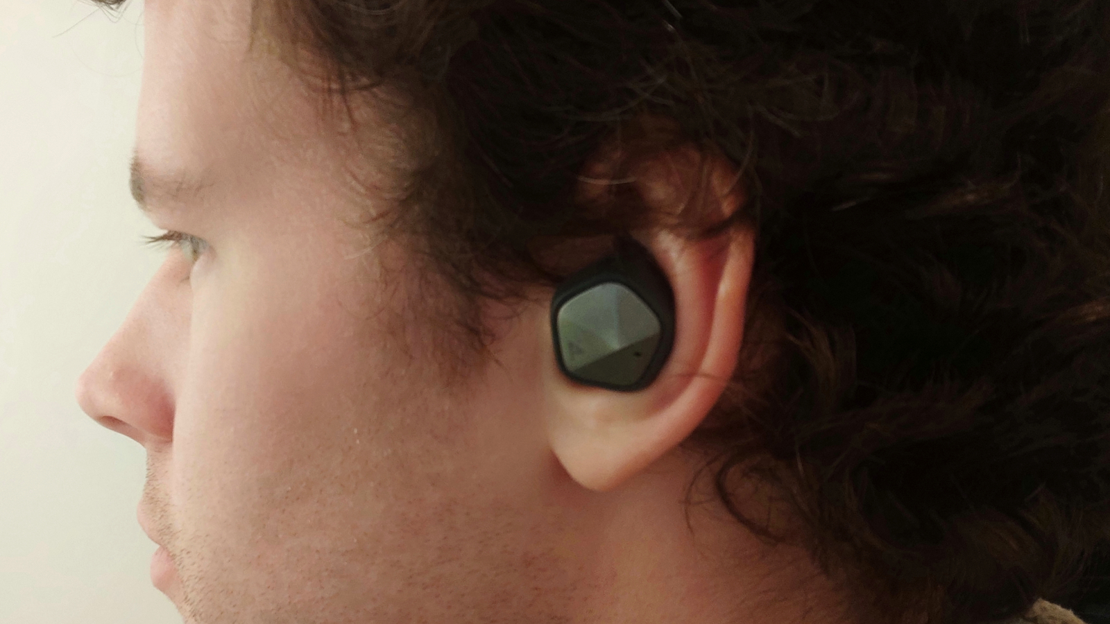 The Astell & Kern AK UW100MKII bud in an ear.