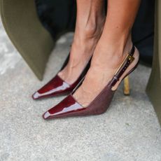 Feet in a pair of brown slingback patent shoes, with soft skin as though she has used one of the best foot scrubs