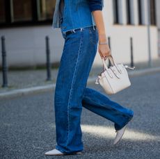 Woman in Levi's blue jeans and a blue denim jacket.